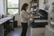 Small business employee scanning documents on a right-sized multifunction copier